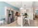 Modern kitchen with stainless steel appliances, granite countertops, and an island with bar seating at 11215 Se 172Nd Place, Summerfield, FL 34491