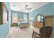 Spacious main bedroom with natural light, fan, and a view to the pool at 11215 Se 172Nd Place, Summerfield, FL 34491