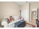 Cozy office area featuring a plush sofa with decorative pillows, desk, and a bright window at 11215 Se 172Nd Place, Summerfield, FL 34491