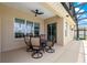 Covered patio featuring a dining table set, offering a perfect space for outdoor relaxation and entertainment at 11215 Se 172Nd Place, Summerfield, FL 34491