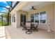 Covered patio featuring a dining table set, offering a perfect space for outdoor relaxation and entertainment at 11215 Se 172Nd Place, Summerfield, FL 34491