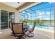 Relaxing pool area with a dining table and chairs under a screened enclosure, perfect for outdoor enjoyment at 11215 Se 172Nd Place, Summerfield, FL 34491
