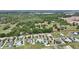 Aerial view of a housing community with colorful homes, trees, and green space at 1127 Fiesta Key Cir, Lady Lake, FL 32159