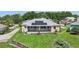 A lush backyard is equipped with solar panels and a covered patio, perfect for relaxing outdoors at 1127 Fiesta Key Cir, Lady Lake, FL 32159