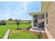 The backyard has green grass and a covered porch with a hammock at 1127 Fiesta Key Cir, Lady Lake, FL 32159