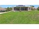 Well manicured lawn, and covered porch at 1127 Fiesta Key Cir, Lady Lake, FL 32159