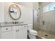 Charming bathroom boasts a stylish vanity with granite countertop and a tiled walk-in shower at 1127 Fiesta Key Cir, Lady Lake, FL 32159