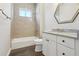 Beautiful bathroom with stylish vanity, granite countertop, modern fixtures and a tiled shower and tub at 1127 Fiesta Key Cir, Lady Lake, FL 32159