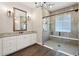 Bathroom boasts double vanity, granite countertop, and glass enclosed shower with seat at 1127 Fiesta Key Cir, Lady Lake, FL 32159