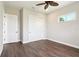 Bedroom with ceiling fan, wood floor, closet, and natural light from a window at 1127 Fiesta Key Cir, Lady Lake, FL 32159