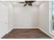 Cozy bedroom featuring hardwood floors, ceiling fan, and bright window at 1127 Fiesta Key Cir, Lady Lake, FL 32159