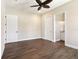 Bedroom featuring hardwood floors, ceiling fan, ensuite bathroom, and plenty of room at 1127 Fiesta Key Cir, Lady Lake, FL 32159