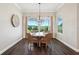 Bright dining room features a modern light fixture and a view of the open backyard at 1127 Fiesta Key Cir, Lady Lake, FL 32159