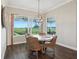 Sunlit dining area boasts an open view of the yard and a stylish wicker dining set at 1127 Fiesta Key Cir, Lady Lake, FL 32159