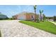 Peach-colored home featuring a paved driveway and an attached two-car garage at 1127 Fiesta Key Cir, Lady Lake, FL 32159