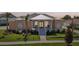 Charming one-story home with a manicured lawn, covered porch, and ample parking in a Gathering-friendly community at 1127 Fiesta Key Cir, Lady Lake, FL 32159