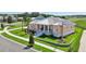 Inviting home with a manicured lawn, covered porch, and beautifully landscaped surroundings at 1127 Fiesta Key Cir, Lady Lake, FL 32159