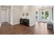 Elegant foyer with hardwood floors, stylish decor, and open access to other living spaces at 1127 Fiesta Key Cir, Lady Lake, FL 32159