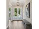 Bright foyer featuring beautiful floors, stylish lighting, and a view of the outdoors at 1127 Fiesta Key Cir, Lady Lake, FL 32159