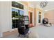 Relaxing front porch seating with stylish chairs and a view, illuminated by modern lighting at 1127 Fiesta Key Cir, Lady Lake, FL 32159