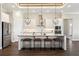The kitchen features pendant lighting, an island with seating, and stainless steel appliances at 1127 Fiesta Key Cir, Lady Lake, FL 32159