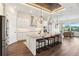 Open kitchen with a large island, pendant lights, and adjacent dining area with backyard views at 1127 Fiesta Key Cir, Lady Lake, FL 32159
