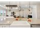 An open kitchen layout featuring an island, a farmhouse sink, and seamless flow into the living area at 1127 Fiesta Key Cir, Lady Lake, FL 32159