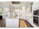 A bright kitchen featuring a large island, stainless steel appliances, and modern finishes at 1127 Fiesta Key Cir, Lady Lake, FL 32159