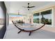 Relaxing screened-in patio with hammock, overhead fans, offering serene outdoor living space at 1127 Fiesta Key Cir, Lady Lake, FL 32159