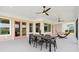 Covered patio with dining area and hammock, offering a perfect blend of comfort and style at 1127 Fiesta Key Cir, Lady Lake, FL 32159