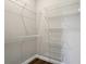 Spacious walk-in closet with wire shelving for efficient storage and organization of your wardrobe at 1127 Fiesta Key Cir, Lady Lake, FL 32159