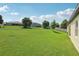 Expansive backyard featuring lush green grass and a picturesque view of neighboring houses at 11313 Little Nellie Dr, Clermont, FL 34711