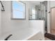 Modern bathroom with shiplap walls, a soaking tub, and frameless shower with black fixtures at 11313 Little Nellie Dr, Clermont, FL 34711