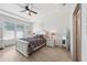 Charming bedroom featuring a tray ceiling, wood floors, and a queen-size bed with decorative pillows at 11313 Little Nellie Dr, Clermont, FL 34711