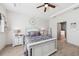 Bright bedroom featuring a tray ceiling, wood floors, and ensuite bathroom access at 11313 Little Nellie Dr, Clermont, FL 34711