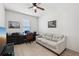 Comfortable bedroom with a ceiling fan, desk, sofa, and plenty of natural light, ideal for work or relaxation at 11313 Little Nellie Dr, Clermont, FL 34711