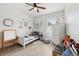 Light-filled bedroom with playful decor and a cozy bed at 11313 Little Nellie Dr, Clermont, FL 34711