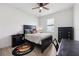Cozy bedroom with dark wood furniture, ceiling fan, and window at 11313 Little Nellie Dr, Clermont, FL 34711