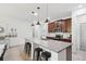 Bright kitchen boasts a large island with seating, pendant lighting, and stainless steel appliances at 11313 Little Nellie Dr, Clermont, FL 34711