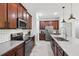 Modern kitchen with stainless steel appliances, stylish countertops, and dark brown cabinetry at 11313 Little Nellie Dr, Clermont, FL 34711