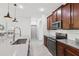 Modern kitchen featuring stainless steel appliances, a central island, and updated cabinets and countertops at 11313 Little Nellie Dr, Clermont, FL 34711