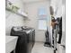 Laundry room with modern washer and dryer, shelving, and ample storage space at 11313 Little Nellie Dr, Clermont, FL 34711