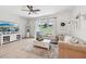 Bright living room features a large sliding door with backyard views and a ceiling fan at 11313 Little Nellie Dr, Clermont, FL 34711