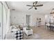 Open-concept living area with contemporary design, wood floors, and seamless access to the kitchen and dining space at 11313 Little Nellie Dr, Clermont, FL 34711