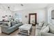 Inviting living room with comfortable couches, decorative pillows, and a unique lighting fixture, creating a cozy ambiance at 11313 Little Nellie Dr, Clermont, FL 34711