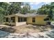 View of the backyard featuring a screened in porch and minimal landscaping at 11495 Se 71St Terrace Rd, Morriston, FL 32668