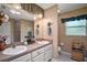 Well-lit bathroom featuring double sinks, a large mirror and a neutral color scheme at 11495 Se 71St Terrace Rd, Morriston, FL 32668