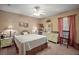 Bedroom with neutral walls, dresser, and a comfortable bed with a patterned bedspread at 11495 Se 71St Terrace Rd, Morriston, FL 32668