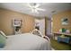 Bright bedroom featuring a white metal bed, beige walls and doorway views to bathroom at 11495 Se 71St Terrace Rd, Morriston, FL 32668