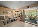 Open dining area featuring tile floors and access to the bright, relaxing sunroom at 11495 Se 71St Terrace Rd, Morriston, FL 32668